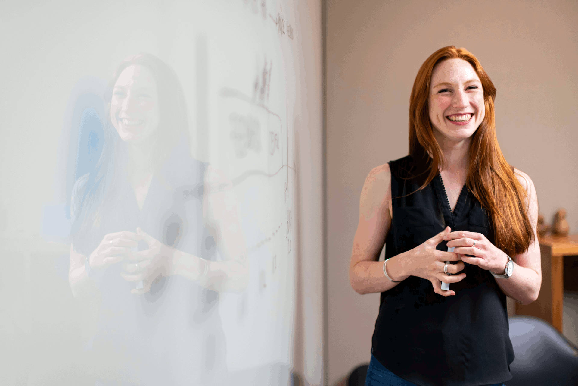 Woman professor next to whiteboard